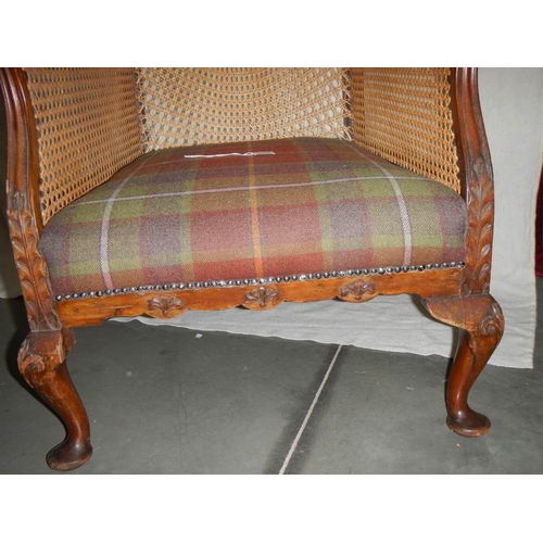 286 - A Victorian mahogany bergere arm chair in excellent condition and with extra cushion.