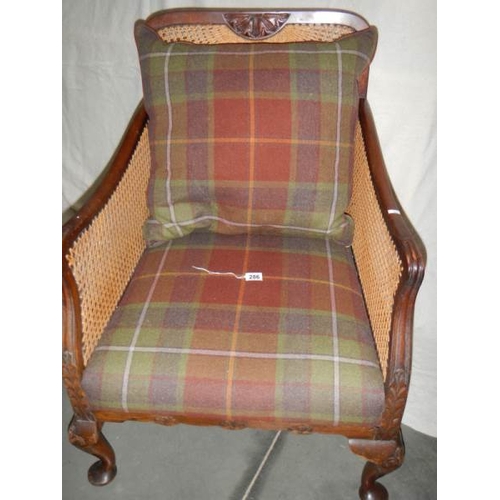 286 - A Victorian mahogany bergere arm chair in excellent condition and with extra cushion.