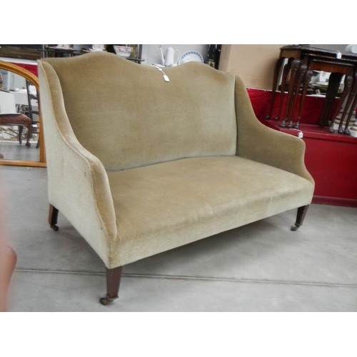 287 - An old French style couch on square legs and with brass castors, in good condition.