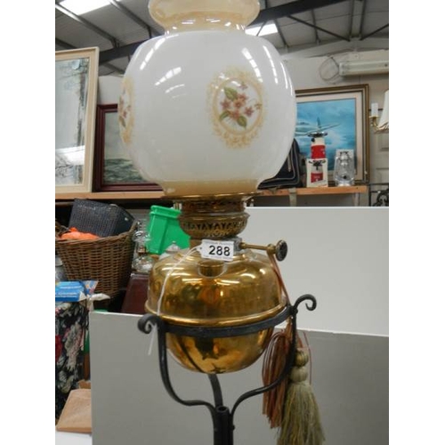 288 - An early 20th century adjustable brass and iron standard oil lamp.