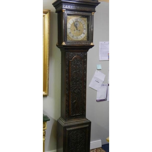 294 - A heavily carved 8 day brass faced Grandfather clock by Geo. Raphams, Brigg.