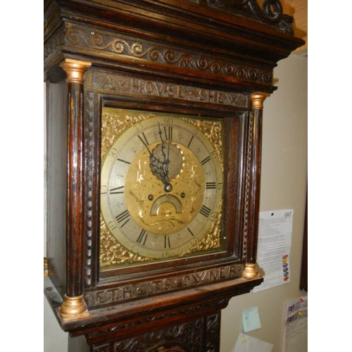 294 - A heavily carved 8 day brass faced Grandfather clock by Geo. Raphams, Brigg.