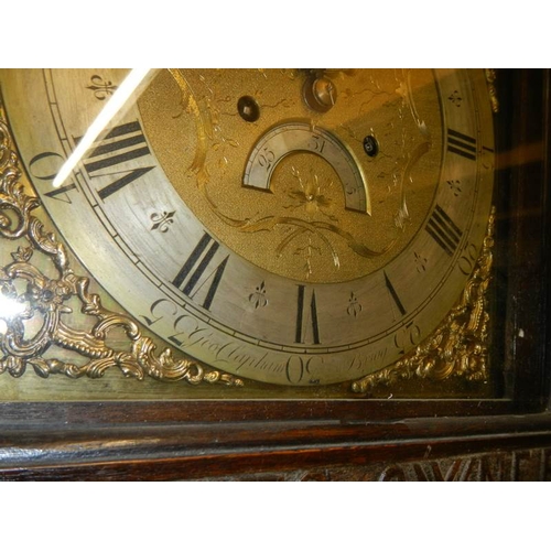 294 - A heavily carved 8 day brass faced Grandfather clock by Geo. Raphams, Brigg.