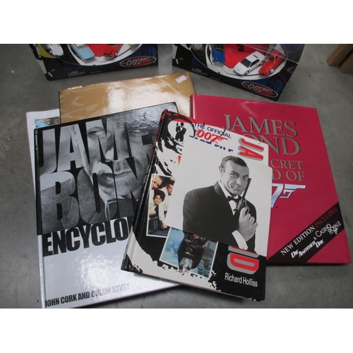 679 - A quantity of James Bond books & 3 x 007 Die cast cars