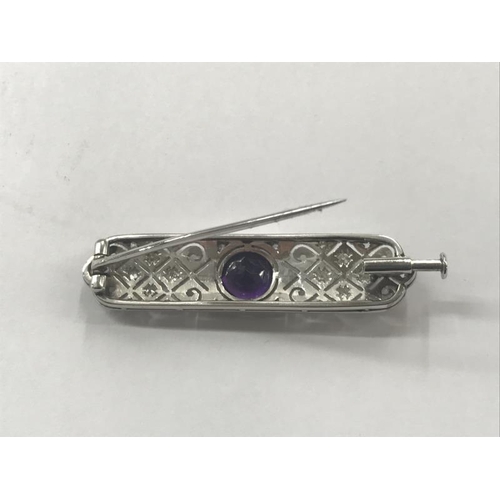 2023 - An Art Deco diamond set brooch with central amethyst set in platinum.