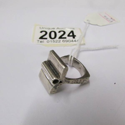 2024 - An unusual abstract silver ring with textured silver shank, dated 1981, size L.