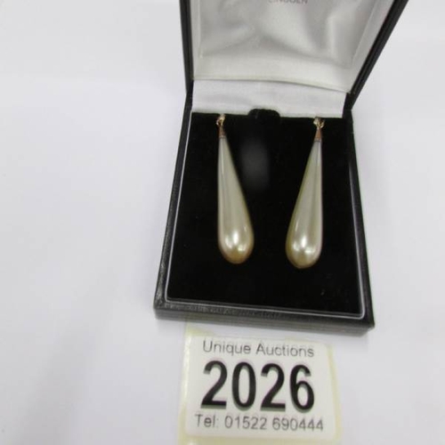 2026 - A pair of vintage pendant earrings with gold shepherd's hook in a cone shape.