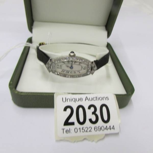 2030 - An Art Deco wristwatch in platinum set with diamonds, with original black silk strap, block clasp st... 