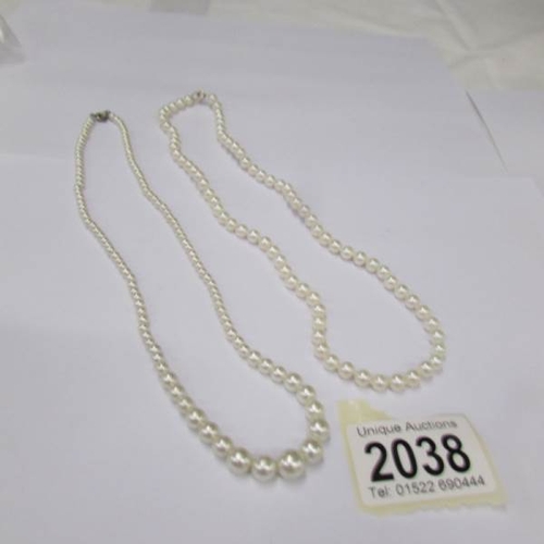 2038 - A pearl necklace and a cultured pearl necklace (one has gold clasp).