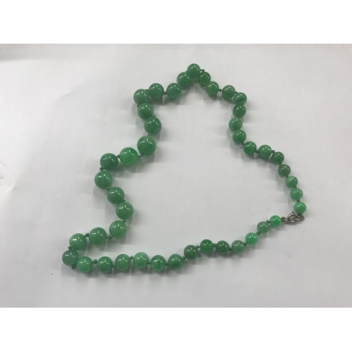 2043 - A green jade bead necklace, a white jade bead necklace and a coral necklace.