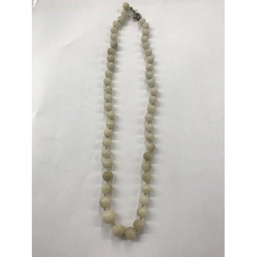 2043 - A green jade bead necklace, a white jade bead necklace and a coral necklace.