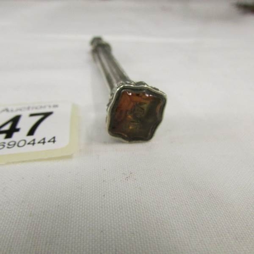 2147 - An unmarked white metal propelling pencil with amber coloured seal to end,.