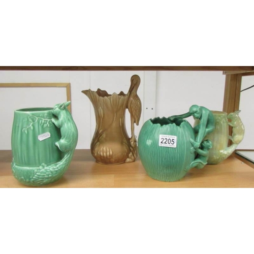 2205 - A Sylvac jug with stork handle, 2 Sylvac jugs with squirrel handles and a green jug with monkey hand... 