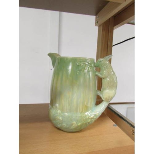 2205 - A Sylvac jug with stork handle, 2 Sylvac jugs with squirrel handles and a green jug with monkey hand... 