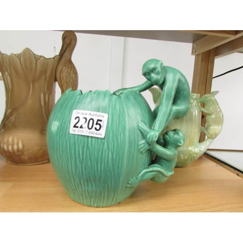 2205 - A Sylvac jug with stork handle, 2 Sylvac jugs with squirrel handles and a green jug with monkey hand... 