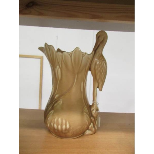 2205 - A Sylvac jug with stork handle, 2 Sylvac jugs with squirrel handles and a green jug with monkey hand... 