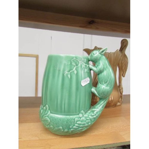 2205 - A Sylvac jug with stork handle, 2 Sylvac jugs with squirrel handles and a green jug with monkey hand... 