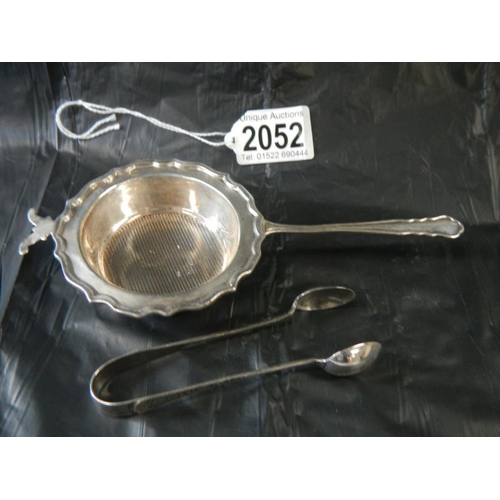 2052 - A silver strainer and silver sugar nips