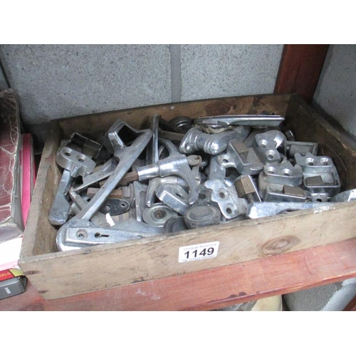 1149 - A box of assorted door and window handles