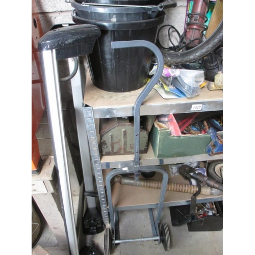 1027 - Four shelves of car bike and trailer spares with tools, boxes, roof rack etc