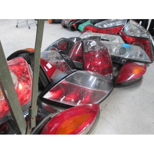 1453 - A huge lot of Ford/Vauxhall etc., front headlamp and rear lamp assemblies.