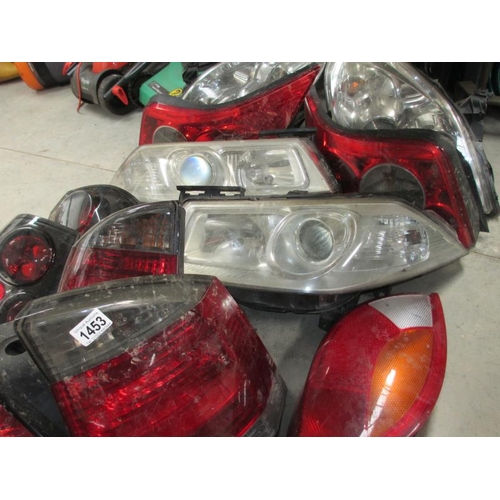 1453 - A huge lot of Ford/Vauxhall etc., front headlamp and rear lamp assemblies.