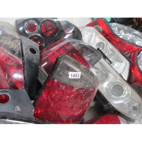 1453 - A huge lot of Ford/Vauxhall etc., front headlamp and rear lamp assemblies.