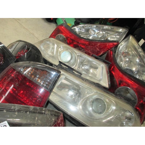 1453 - A huge lot of Ford/Vauxhall etc., front headlamp and rear lamp assemblies.