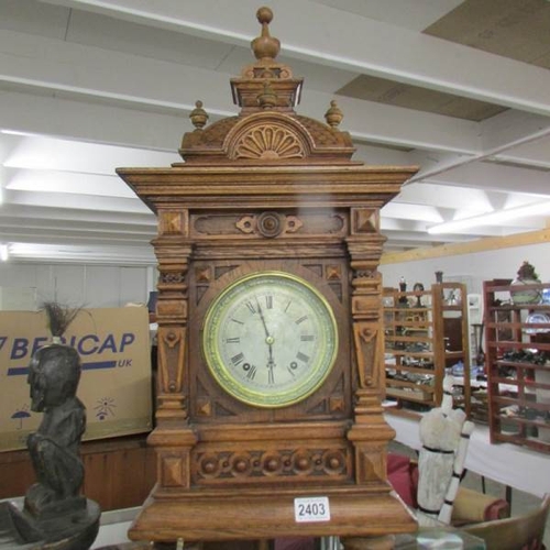 2403 - A late Victorian tall oak mantel/bracket clock with silvered dial, in very good condition. 28