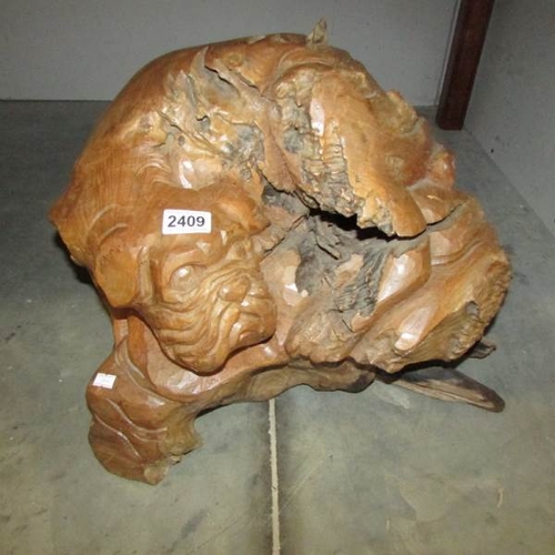 2409 - A swamp wood carving of a dog.