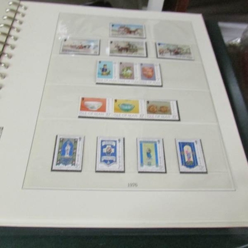 2466 - An album of Isle of Man stamps and an album of Gibraltar stamps.