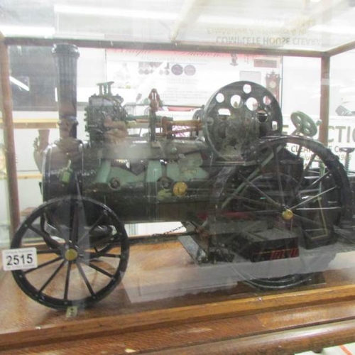 2515 - A handbuilt clockwork traction engine in custom built case on stand.  Cabinet is 78cm long x 46.5cm ... 