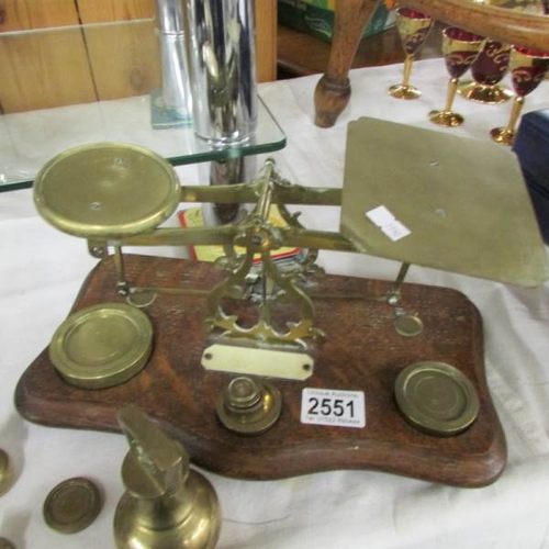 2551 - 2 sets of postal scales and a quantity of weights.