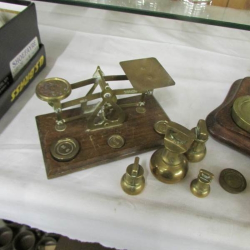 2551 - 2 sets of postal scales and a quantity of weights.