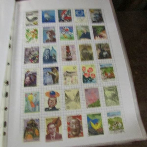 2593 - £ stamp folders containing a good selection of world stamps.