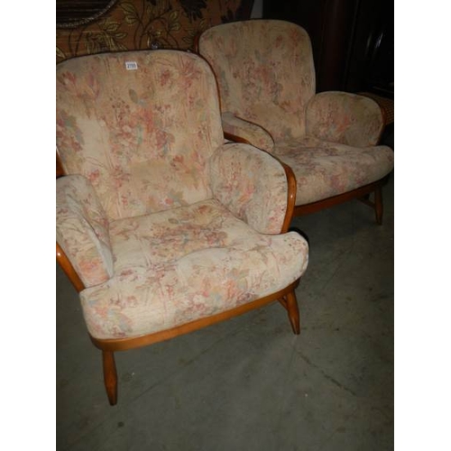 2705 - A pair of arm chairs.