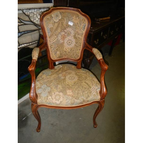 2714 - An upholstered elbow chair.