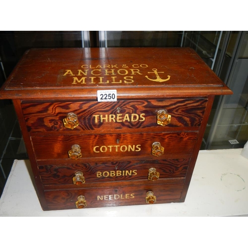 2250 - A small pitch pine chest with 4 drawers advertising cottons and bobbins and threads