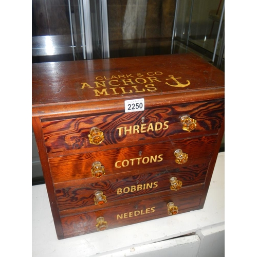 2250 - A small pitch pine chest with 4 drawers advertising cottons and bobbins and threads