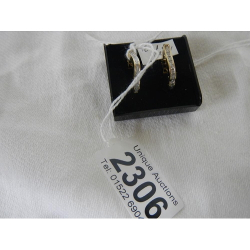 2306 - A pair of 14ct gold channel set diamond earrings.