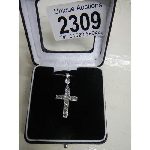 2309 - A diamond set cross old cut stones in white gold with attached 18ct white gold chain.