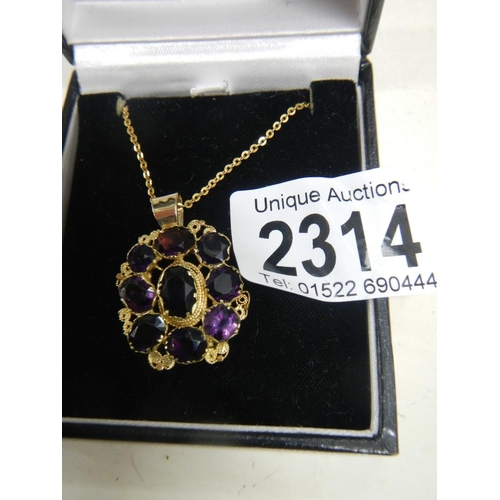 2314 - A Victorian mixed cut amethyst pendant in gold cannetille setting on yellow metal chain.

The part t... 