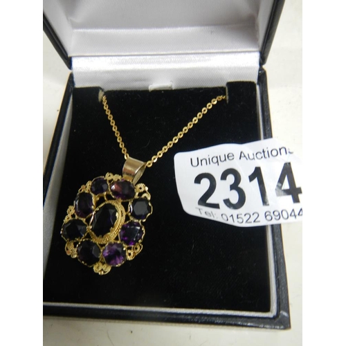 2314 - A Victorian mixed cut amethyst pendant in gold cannetille setting on yellow metal chain.

The part t... 