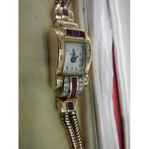 2316 - An art deco diamond/ruby watch in 9ct gold, in working order, total weight 30 grams, 8 calibre cut r... 