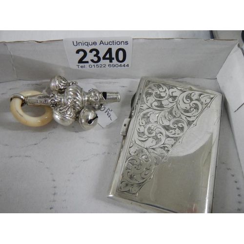 2340 - A silver cigarett case and a white metal babies rattle.