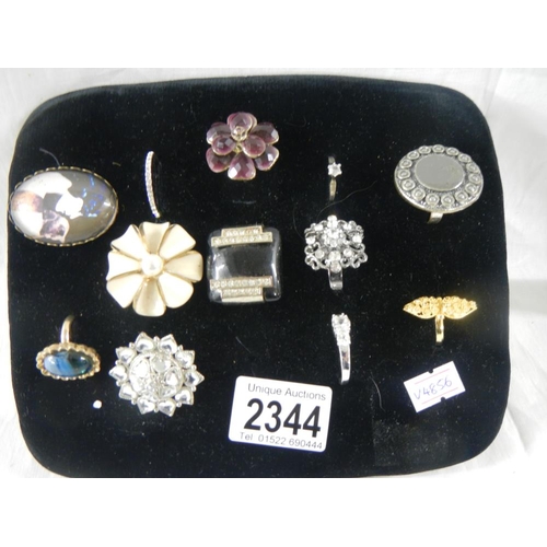 2344 - A mixed lot of costume jewellery including brooches, rings etc.,