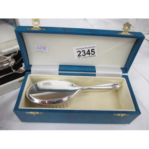 2345 - A boxed silver plate cruet set and a boxed silver plate brush.