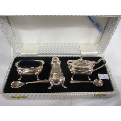 2345 - A boxed silver plate cruet set and a boxed silver plate brush.