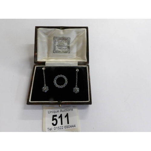 511 - A pair of early 20th century paste set ear pendants and a matching brooch in silver and in original ... 