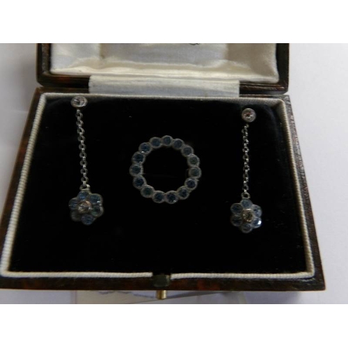 511 - A pair of early 20th century paste set ear pendants and a matching brooch in silver and in original ... 